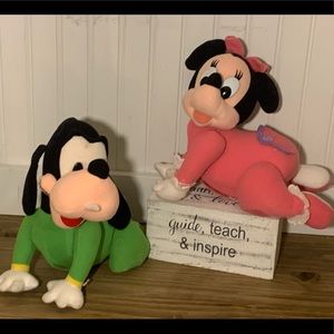 Crawling Minni mouse and goofy stuffed animals